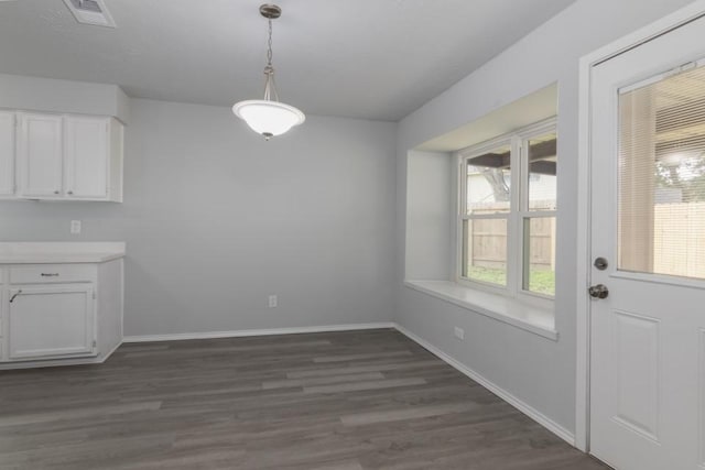 unfurnished dining area with dark hardwood / wood-style floors