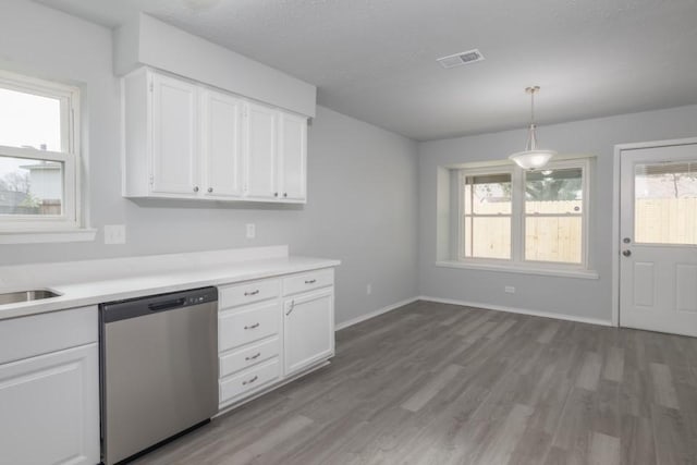 kitchen with light hardwood / wood-style flooring, dishwasher, white cabinets, and hanging light fixtures