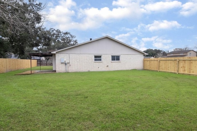 rear view of house featuring a lawn