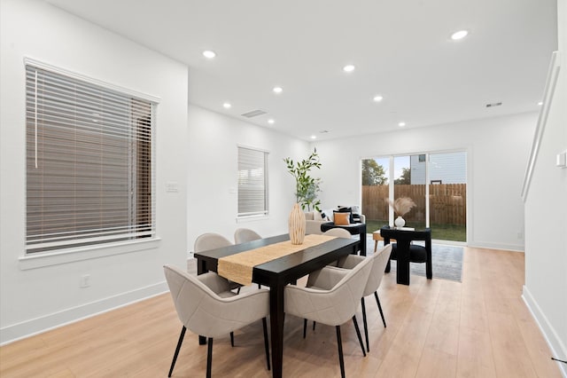 dining space with light hardwood / wood-style flooring