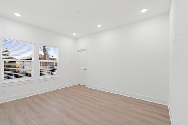 empty room with light hardwood / wood-style flooring