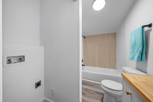 full bathroom with vanity, toilet, wood-type flooring, and tiled shower / bath