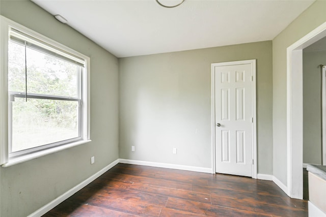 empty room with dark hardwood / wood-style floors