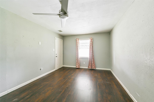 empty room featuring ceiling fan and dark hardwood / wood-style flooring