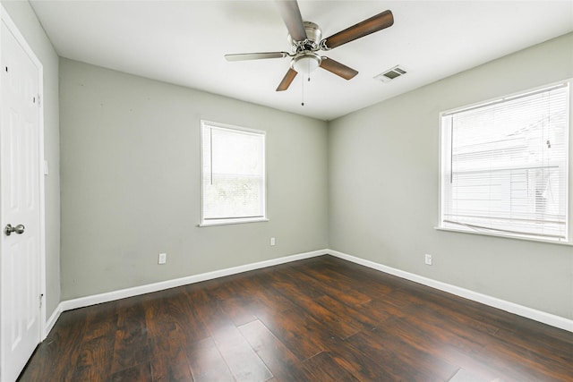 unfurnished room with ceiling fan and dark hardwood / wood-style flooring