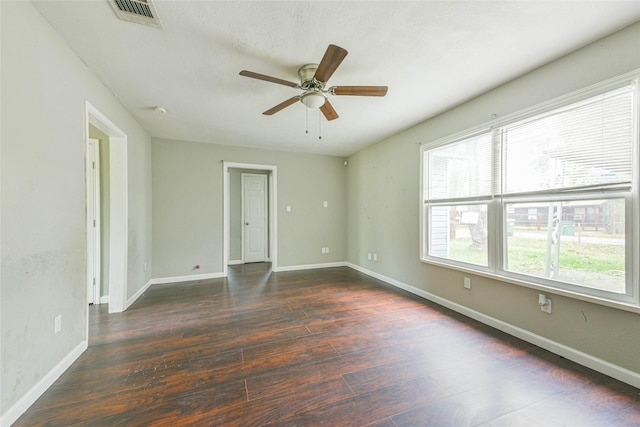 unfurnished room featuring ceiling fan and dark wood-type flooring