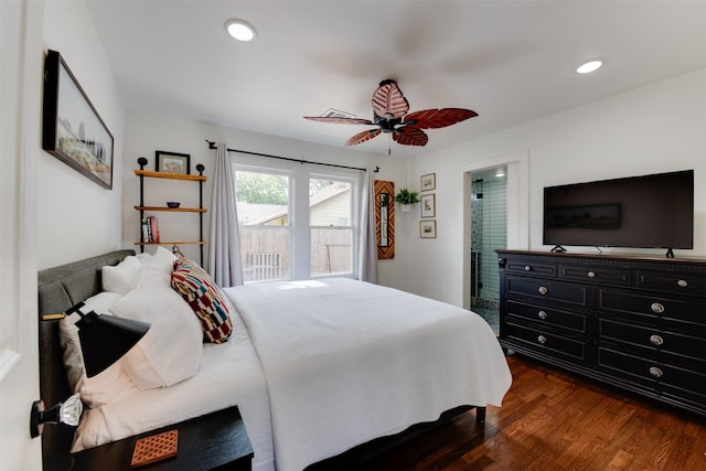 bedroom featuring ceiling fan, dark wood-type flooring, and connected bathroom