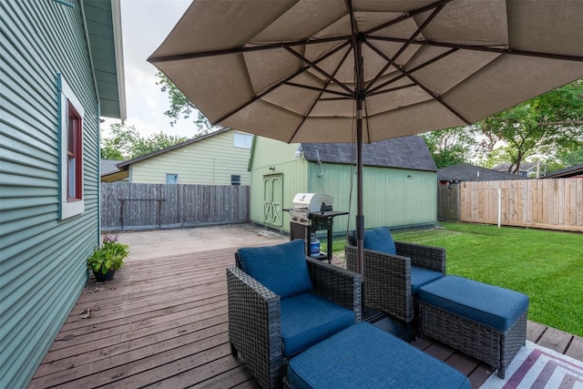 deck with a shed, a lawn, and a grill