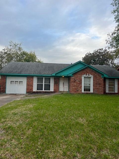 ranch-style home featuring a garage and a front yard