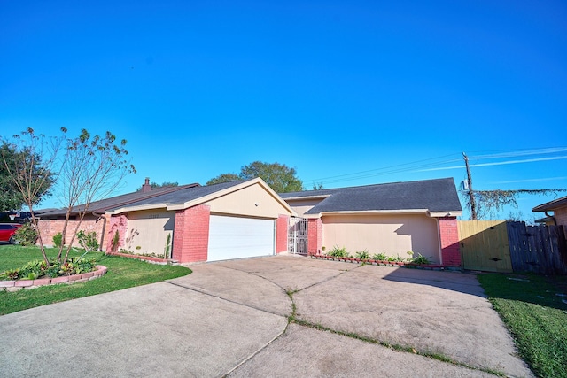 single story home with a front yard and a garage