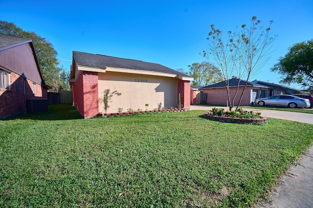 view of side of property with a lawn