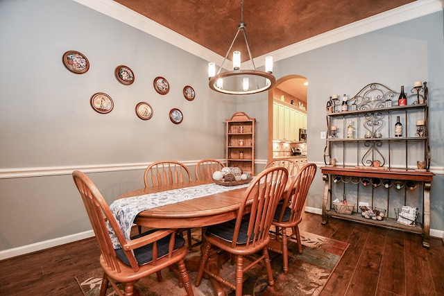 dining room featuring dark hardwood / wood-style floors and ornamental molding