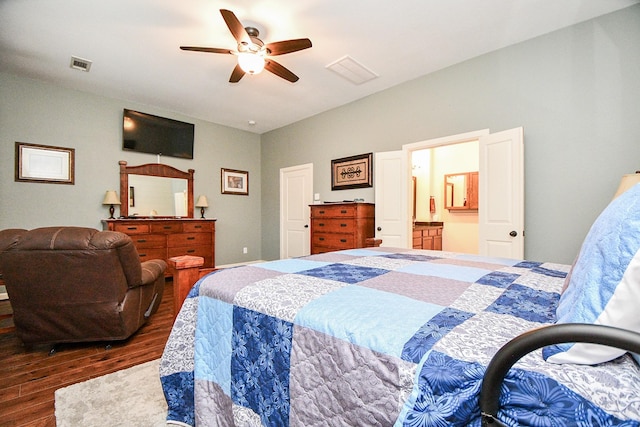 bedroom featuring connected bathroom, ceiling fan, and dark wood-type flooring