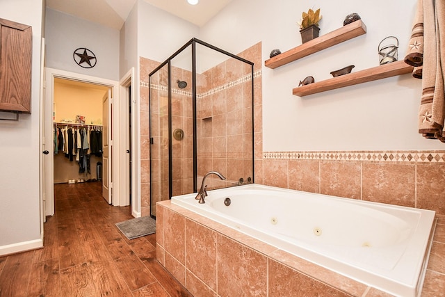 bathroom featuring separate shower and tub and wood-type flooring