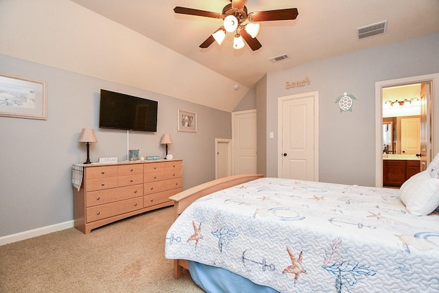 carpeted bedroom featuring connected bathroom, vaulted ceiling, and ceiling fan