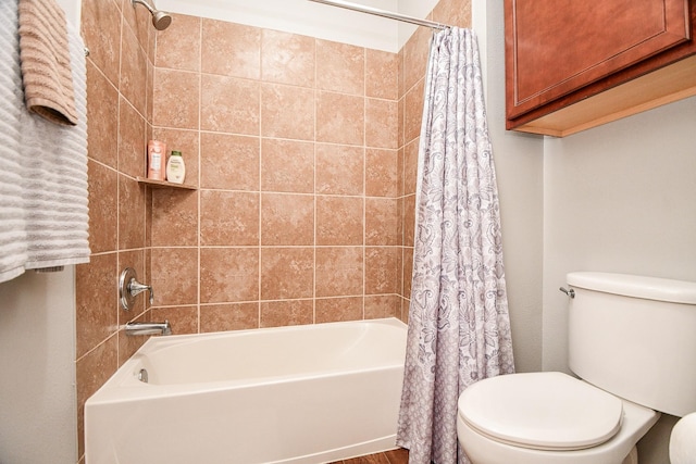 bathroom featuring shower / bath combination with curtain and toilet