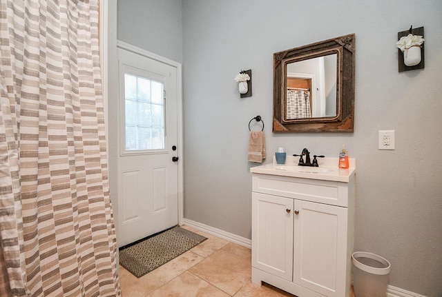 doorway featuring light tile patterned floors and sink