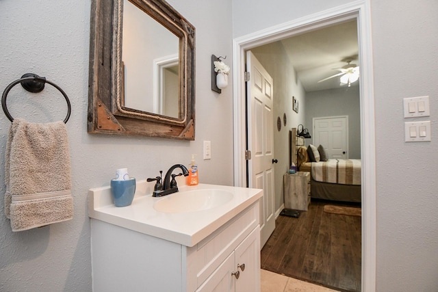 bathroom featuring vanity, ceiling fan, and wood-type flooring