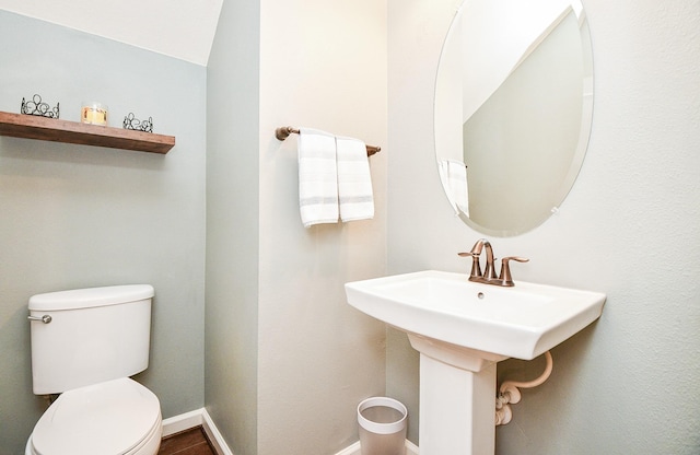 bathroom with lofted ceiling and toilet