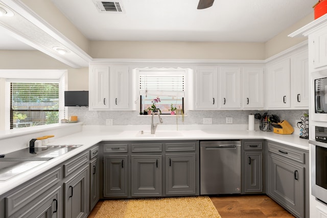 kitchen featuring white cabinets, dishwasher, gray cabinets, and sink