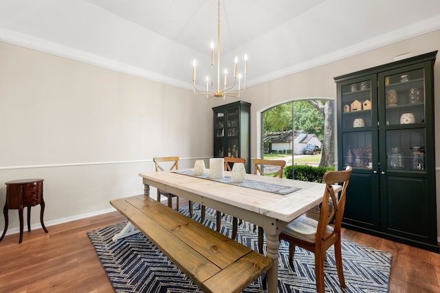 dining space featuring crown molding, dark hardwood / wood-style floors, and a notable chandelier