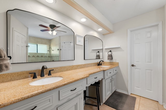 bathroom with a tile shower, ceiling fan, tile patterned floors, and vanity