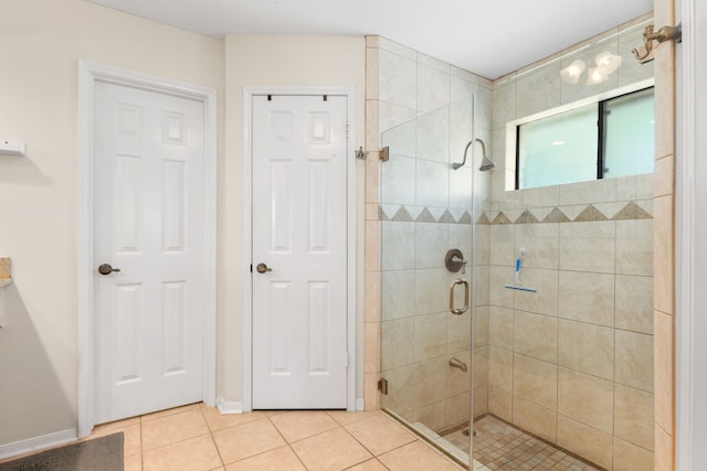 bathroom featuring tile patterned flooring and a shower with shower door