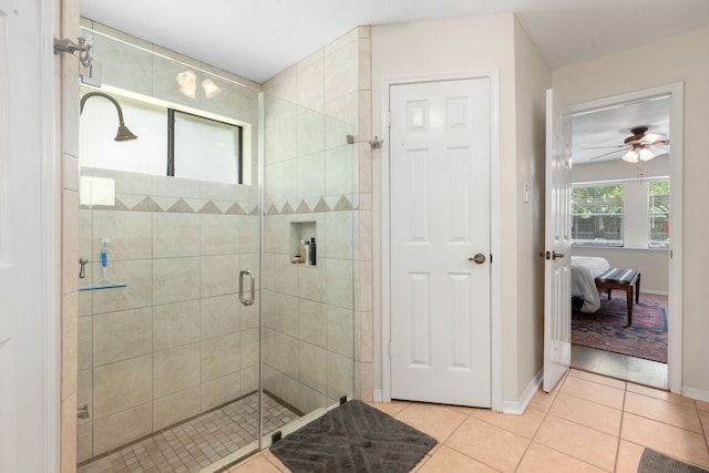 bathroom with a shower with door, tile patterned floors, and ceiling fan