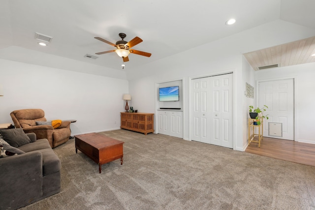 carpeted living room featuring ceiling fan and lofted ceiling