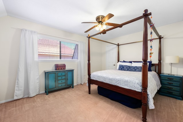 bedroom with light colored carpet, ceiling fan, and lofted ceiling