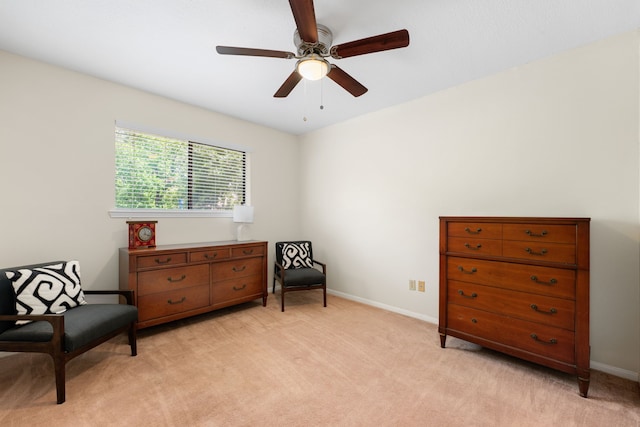 living area featuring ceiling fan and light carpet