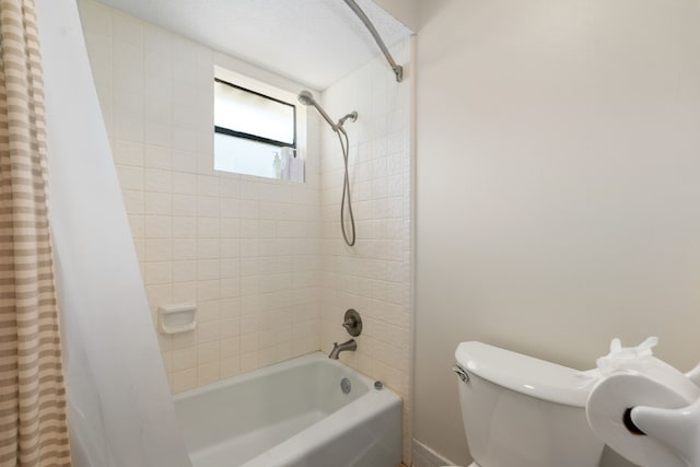 bathroom featuring shower / bath combo and toilet