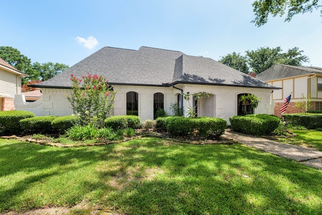 french country style house with a front lawn