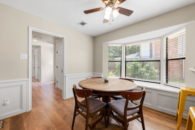 dining room with ceiling fan and light wood-type flooring