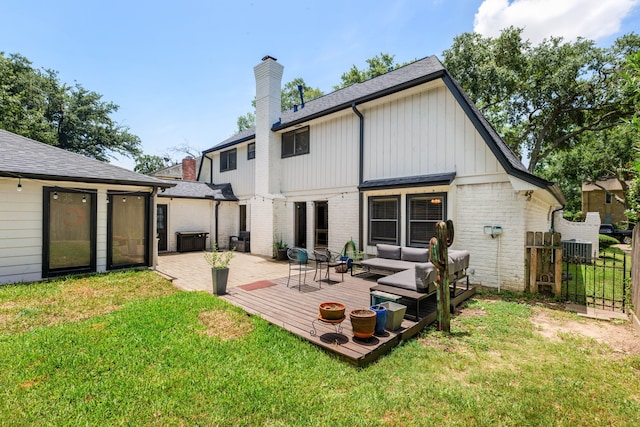 rear view of property featuring an outdoor living space and a yard