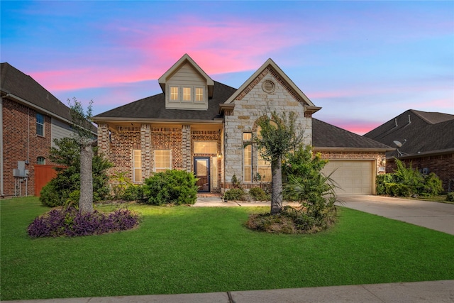 view of front of house featuring a yard and a garage