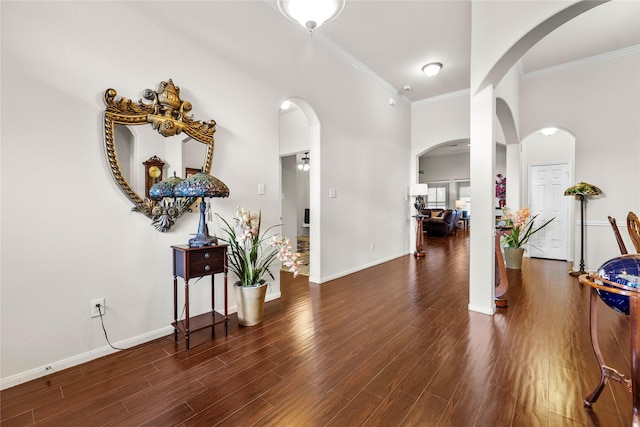 foyer with ornamental molding and dark wood-type flooring