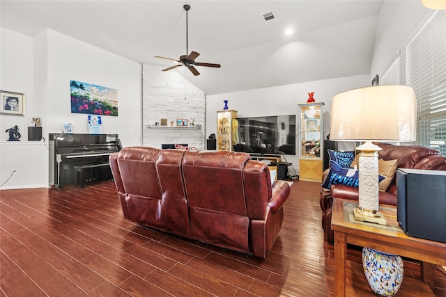 living room featuring dark hardwood / wood-style flooring, vaulted ceiling, and ceiling fan