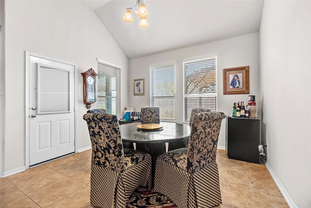 dining room with light tile patterned floors, a notable chandelier, and high vaulted ceiling