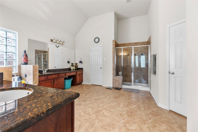 bathroom featuring tile patterned floors, vanity, high vaulted ceiling, and an enclosed shower