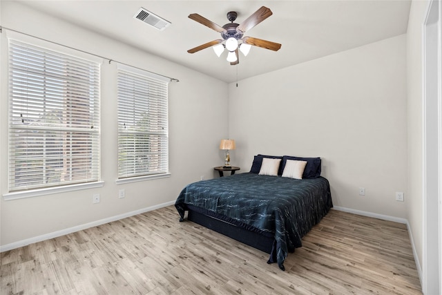 bedroom with light hardwood / wood-style flooring and ceiling fan