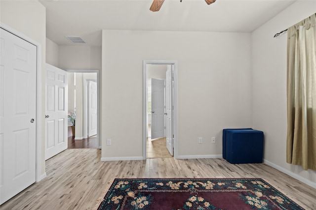 unfurnished bedroom featuring ceiling fan and light hardwood / wood-style flooring