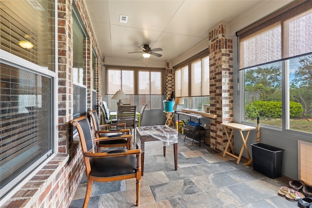 sunroom featuring plenty of natural light and ceiling fan