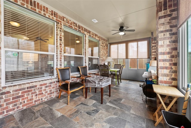 sunroom featuring ceiling fan