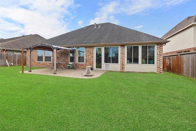 back of house featuring a patio area and a yard