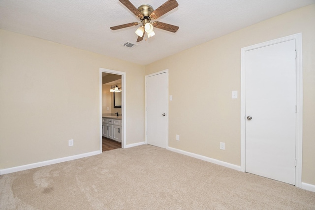 empty room with ceiling fan, sink, and carpet floors