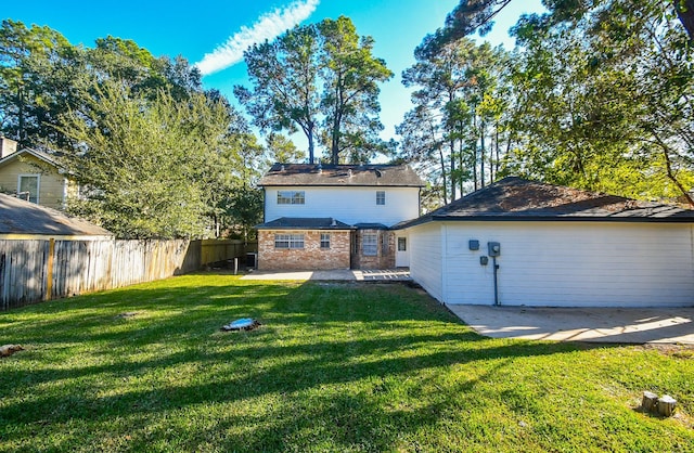 rear view of house with a yard and a patio