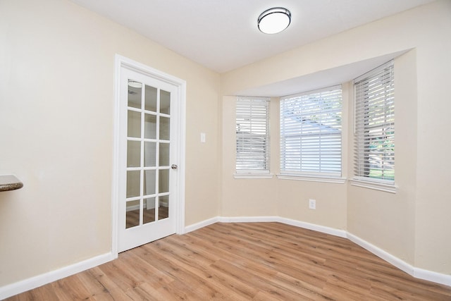 unfurnished room with light hardwood / wood-style flooring