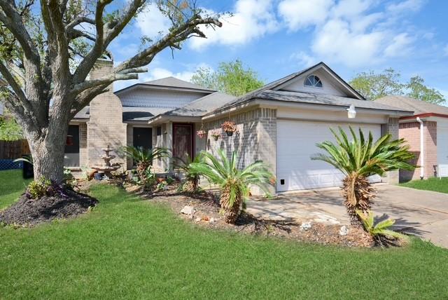 view of front of property featuring a front lawn and a garage