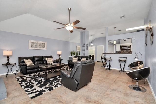 living room with ceiling fan and lofted ceiling